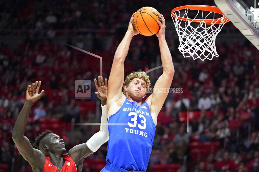 Rick Bowmer BYU forward Caleb Lohner (33) pulls down a rebound as Utah guard Both Gach, left, defends in the first half during an NCAA college basketball game Saturday, Nov. 27, 2021, in Salt Lake City. (AP Photo/Rick Bowmer)