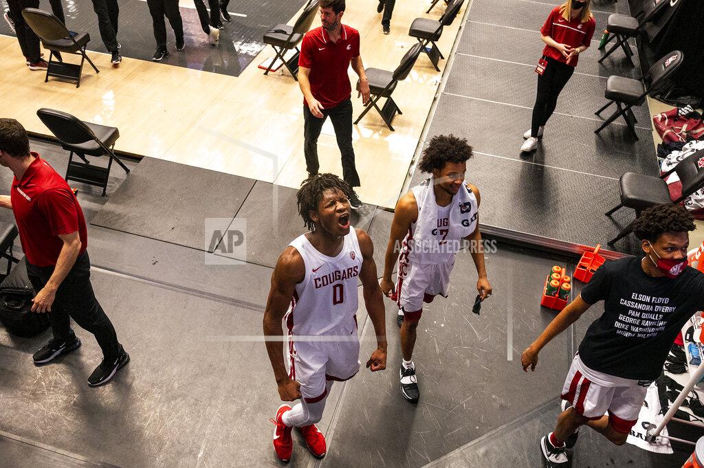 Pete Caster FILE - In this Saturday, Feb. 20, 2021 file photo, Washington State center Efe Abogidi, centre, celebrates alongside guard Myles Warren (2) after beating Stanford, in an NCAA college basketball game, in Pullman, Wash. A serious knee injury nearly ended Efe Abogidi's basketball career but he's now back on the NBA draft radar. The 19-year-old Nigerian is known for his high-flying dunks and plays for Washington State in the Pac-12. But his journey from West Africa to the West Coast was atypical with stops in Senegal and Australia. (AP Photo/Pete Caster,File)