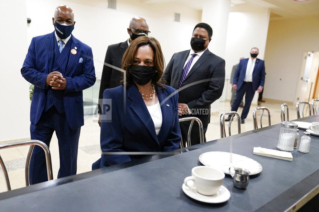 Carolyn Kaster Vice President Kamala Harris sits at the lunch counter where four Black students sat down at Woolworth's lunch counter in Greensboro, N.C., and ordered coffee, during her visit to the International Civil Rights Center and Museum, Monday, April 19, 2021, in Greensboro, N.C. With Harris are Melvin Skip Alston-Guilford, County Board of Commissioners, Rev. Anthony Spearman and museum director John Swain. Harris is sitting in the same chair that Rosa Parks sat in during a visit in 1995. (AP Photo/Carolyn Kaster)
