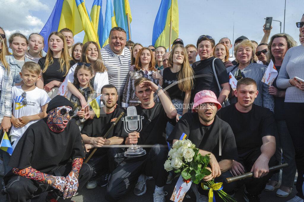 Mykola Tys Oleh Psiuk, second from right, frontman of Ukraine's Kalush Orchestra, winners of the Eurovision Song Contest, and his band pose with the trophy in Krakovets, at the Ukraine border with Poland, Monday, May 16, 2022. (AP Photo/Mykola Tys)