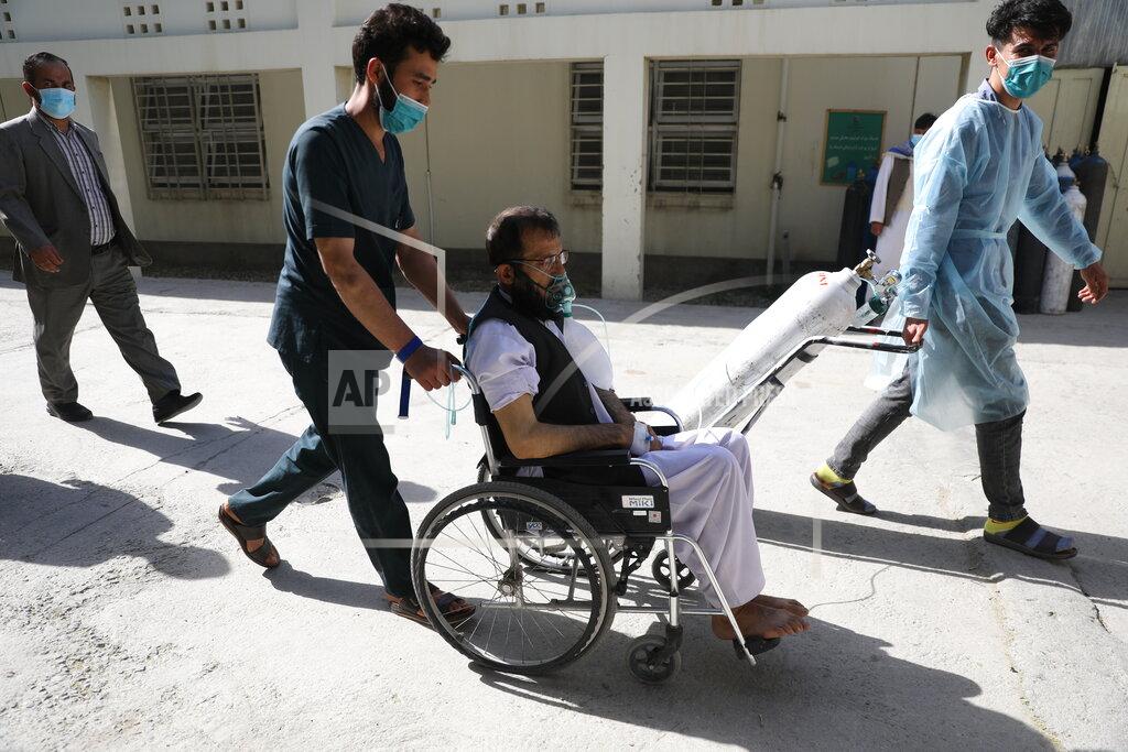Rahmat Gul Afghan doctors wheel a patient breathing through an oxygen mask at the Afghan-Japan Communicable Disease Hospital to a special ward for COVID-19 patients, in Kabul, Afghanistan, Sunday, May 30, 2021. Afghanistan is battling a brutal third wave of COVID infections, while health officials plead for vaccines, expressing deep frustration at the inequities of the global vaccine distribution. Positive COVID cases jump from eight percent to 60 per cent in some parts of the country. (AP Photo/Rahmat Gul)