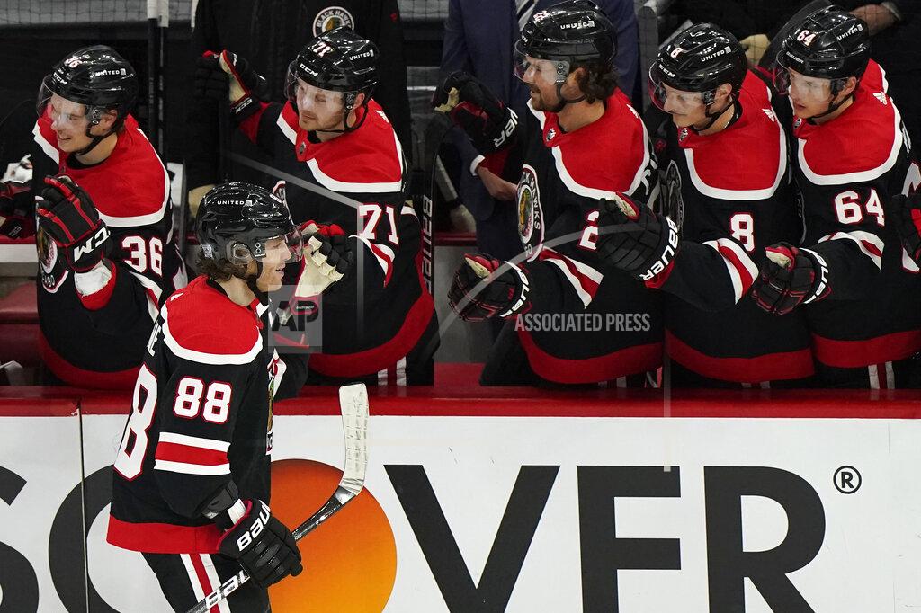 Nam Y. Huh Chicago Blackhawks' Patrick Kane (88) celebrates with teammates after scoring a goal against the Detroit Red Wings during the third period of an NHL hockey game in Chicago, Sunday, Feb. 28, 2021. It was 400th goals from Patrick Kane. (AP Photo/Nam Y. Huh)