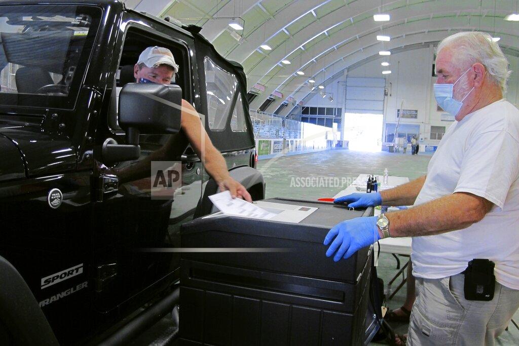 Lisa Rathke Voter Bill Young casts a ballot in Vermont's statewide primary on Tuesday, Aug. 11, 2020, in Barre, Vt. The city provided drive-thru voting in the Barre Civic Center. (AP Photo/Lisa Rathke)