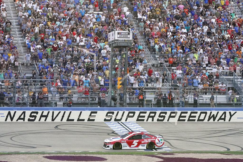 Mark Humphrey Kyle Larson (5) crosses the finish line to win a NASCAR Cup Series auto race at Nashville Superspeedway Sunday, June 20, 2021, in Lebanon, Tenn. (AP Photo/Mark Humphrey)