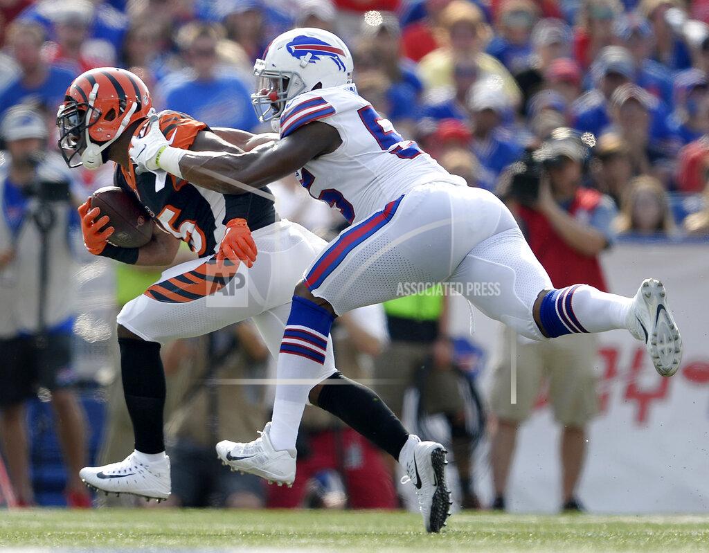 FILE - In this Aug. 26, 2018, file photo, Cincinnati Bengals running back Giovani Bernard, left, is tackled by Buffalo Bills defensive end Jerry Hughes during the first half of a preseason NFL football game in Orchard Park, N.Y. The Bengals travel to Orchard Park this week for the Bills' home-opener. (AP Photo/Adrian Kraus, File)