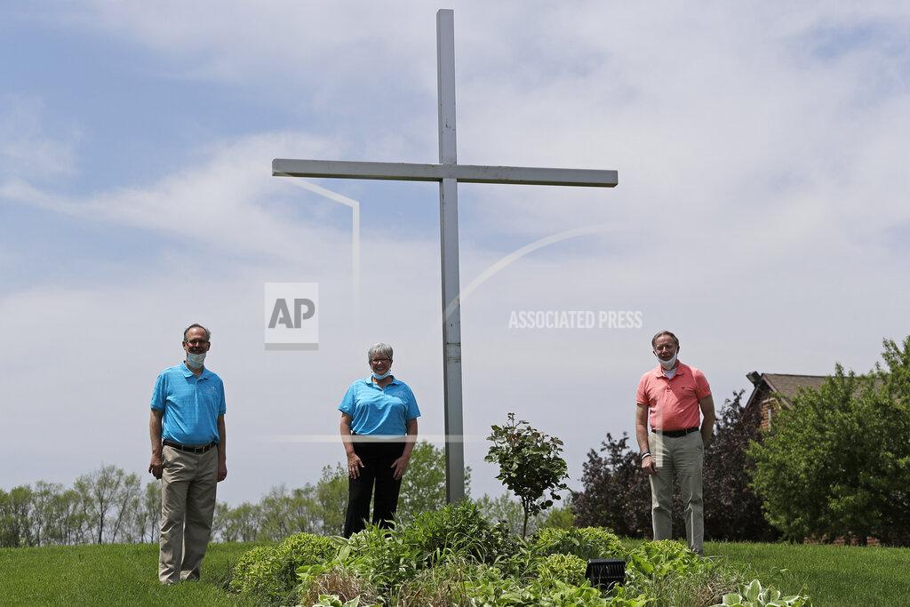 Nam Y. Huh Senior Pastor Kendall Koenig, left, Associate Pastor Sharon Rogers, center, and PATH Manager Jared Skorburg pose for a photo at Light of Christ Lutheran Church in Algonquin, Ill., Sunday, May 24, 2020. “The church is not a building, the church is people,” said Rogers, explaining why parents had embraced the idea of an outdoor service for their children's upcoming confirmation ceremony. (AP Photo/Nam Y. Huh)