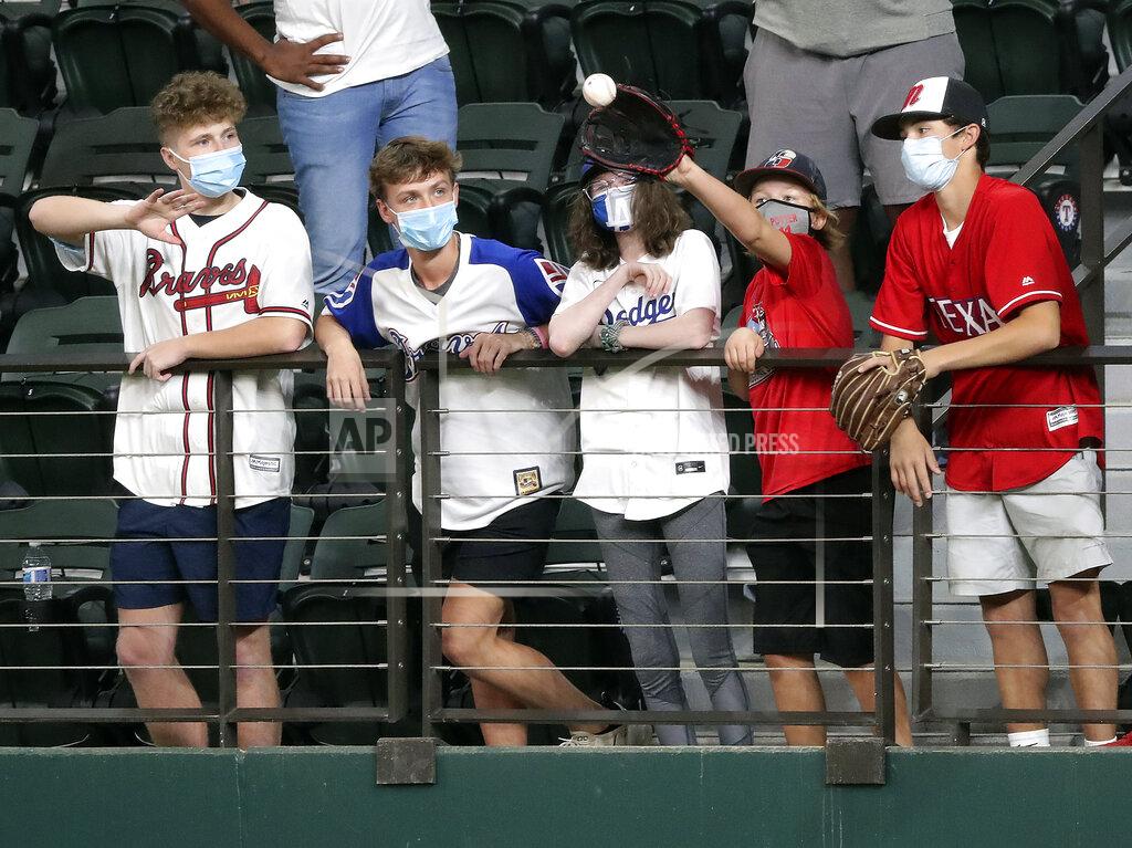 Curtis Compton Fans in center field catch home run balls while the Atlanta Braves take batting practice before playing the Los Angeles Dodgers in Game 1 of a baseball National League Championship Series, Monday, Oct. 12, 2020, in Arlington, Texas. (Curtis Compton/Atlanta Journal-Constitution via AP)