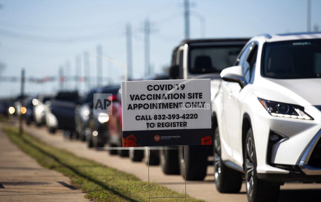 Yi-Chin Lee People who qualify under Phase 1A or Phase 1B of the state's guidelines wait for their turn to receive the COVID-19 vaccine Sunday, Jan. 3, 2021, at a Houston Health Department's COVID-19 vaccine clinic in Houston. The department vaccinated 1,008 people who qualify under Phase 1A or Phase 1B of the state's guidelines at the clinic's first day on Saturday. (Yi-Chin Lee/Houston Chronicle via AP)