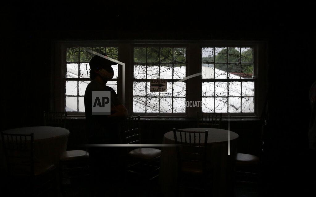 Brynn Anderson A person waits in line to vote in the Georgia's primary election at Park Tavern on Tuesday, June 9, 2020, in Atlanta. (AP Photo/Brynn Anderson)