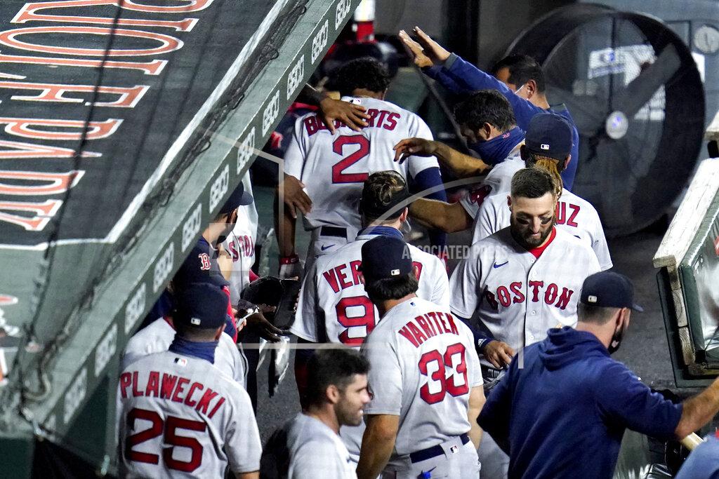 Julio Cortez Boston Red Sox's Xander Bogaerts (2) is greeted in the dugout after hitting a solo home run off Baltimore Orioles starting pitcher Asher Wojciechowski during the third inning of a baseball game, Thursday, Aug. 20, 2020, in Baltimore. (AP Photo/Julio Cortez)