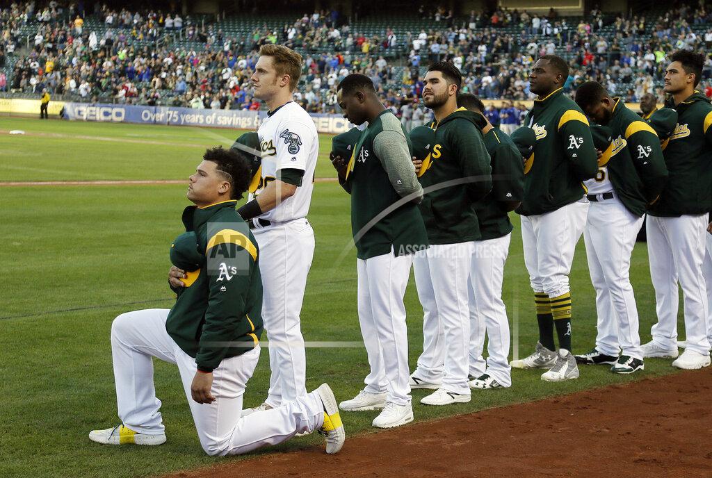 Eric Risberg FILE - In this Sept. 23, 2017, file photo, Oakland Athletics catcher Bruce Maxwell kneels during the national anthem before the team's baseball game against the Texas Rangers in Oakland, Calif. Maxwell is the only major leaguer to take a knee during the playing of "The Star-Spangled Banner" before a game. Major leaguers have not, in general, been the first set of players in pro sports to speak out on issues of social injustice. We'll see what stances they take on and off the field when games return. (AP Photo/Eric Risberg, File)