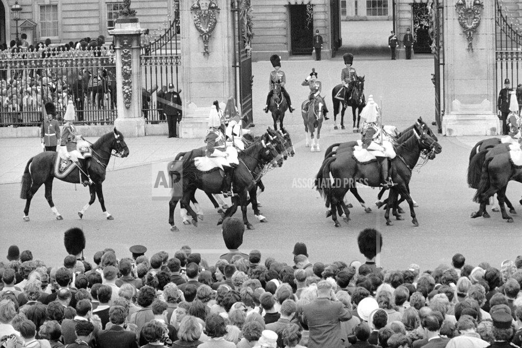 Bippa FILE - In this file photo dated June 13, 1964, Britain's Queen Elizabeth II and Prince Philip, left, take the salute as the Sovereign Escort of the Household Cavalry ride past Buckingham Palace in London. The ceremony marked the Queen's official birthday, her 38th, and the Colour trooped was that the First Battalion of the Coldstream Guards. Prince Philip who died Friday April 9, 2021, aged 99, lived through a tumultuous century of war and upheavals, but he helped forge a period of stability for the British monarchy under his wife, Queen Elizabeth II. (AP Photo, FILE)