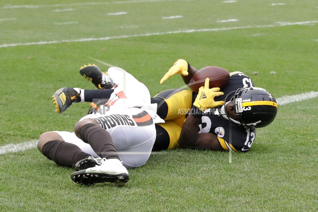 Gene J. Puskar Pittsburgh Steelers wide receiver James Washington (13) grabs for the ball as he tries for a catch over Cleveland Browns defensive back Sheldrick Redwine (29) during the first half of an NFL football game, Sunday, Dec. 1, 2019, in Pittsburgh. The play was ruled a catch for a touchdown. (AP Photo/Gene J. Puskar)
