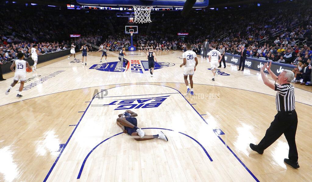 Julio Cortez Georgetown forward Josh LeBlanc lies on the court after taking a fall on a play against Seton Hall during the first half of an NCAA college basketball game in the Big East men's tournament, Thursday, March 14, 2019, in New York. Seton Hall won 73-57. (AP Photo/Julio Cortez)
