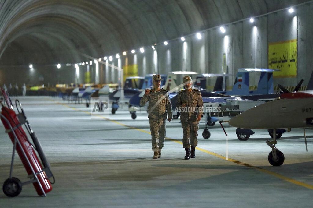Uncredited In this photo released on Saturday, May 28, 2022 by website of the Iranian Army, Chief of the General Staff of the Armed Forces Gen. Mohammad Hossein Bagheri, left, and Commander of the Army Gen. Abdolrahim Mousavi visit an underground drone base tunnel of the Army in the heart of the country's western Zagros Mountains. Iranian state television's report said Saturday, May 29 the tunnel was some 100 meters (330 feet) underground and was home to the Kaman-22 and Fotros drones, both capable of carrying cruise missiles. (Iranian Army via AP)