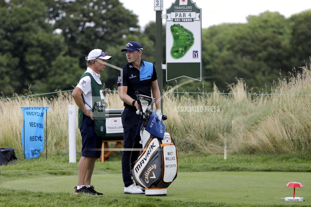 Frank Franklin Ii Matt Wallace, right, of England, stands with his caddie David McNeilly before teeing off on the third hole during the second round of the Travelers Championship golf tournament at TPC River Highlands, Friday, June 26, 2020, in Cromwell, Conn. Wallace is playing the second round by himself after two other golfers in his group, Denny McCarthy and Bud Cauley, withdrew from the tournament. McCarthy told Golfchannel.com that he withdrew from the tournament after feeling sick Thursday night and testing positive for the coronavirus on Friday. Cauley, who played with McCarthy on Thursday, also withdrew before Friday's second round. McCarthy became the third PGA Tour player to test positive for the virus since its restart and the second this week, joining Cameron Champ who withdrew on Tuesday. Nick Watney withdrew just before the second round of last week's RBC Heritage Championship. (AP Photo/Frank Franklin II)