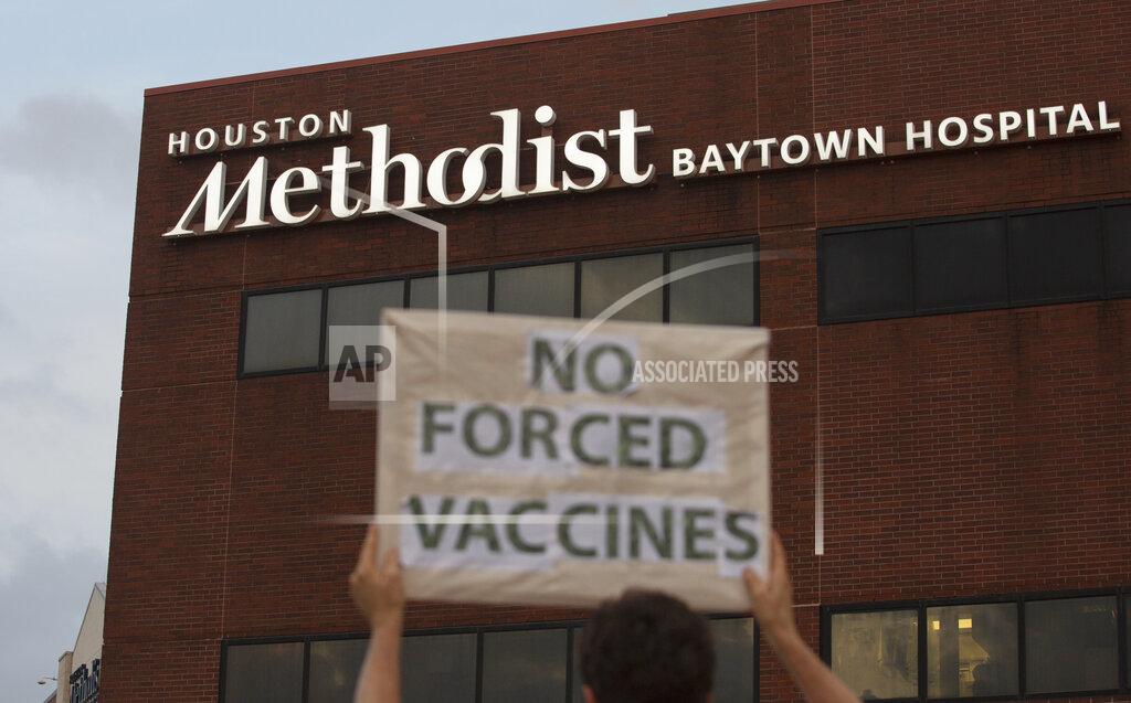 Yi-Chin Lee FILE - In this June 7, 2021, file photo, a person holds a sign to protest at Houston Methodist Hospital in Baytown, Texas, a policy that says hospital employees must get vaccinated against COVID-19 or lose their jobs. A federal judge dismissed their lawsuit, saying if workers don’t like the rule, they can go find another job. (Yi-Chin Lee/Houston Chronicle via AP, File)