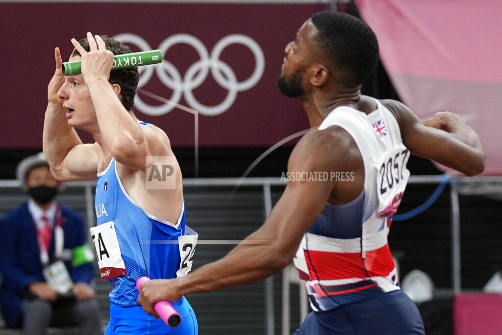 David J. Phillip Filippo Tortu, of Italy, left, reacts after his team won the men's 4x100-meter relay final at the 2020 Summer Olympics, Friday, Aug. 6, 2021, in Tokyo. (AP Photo/David J. Phillip)