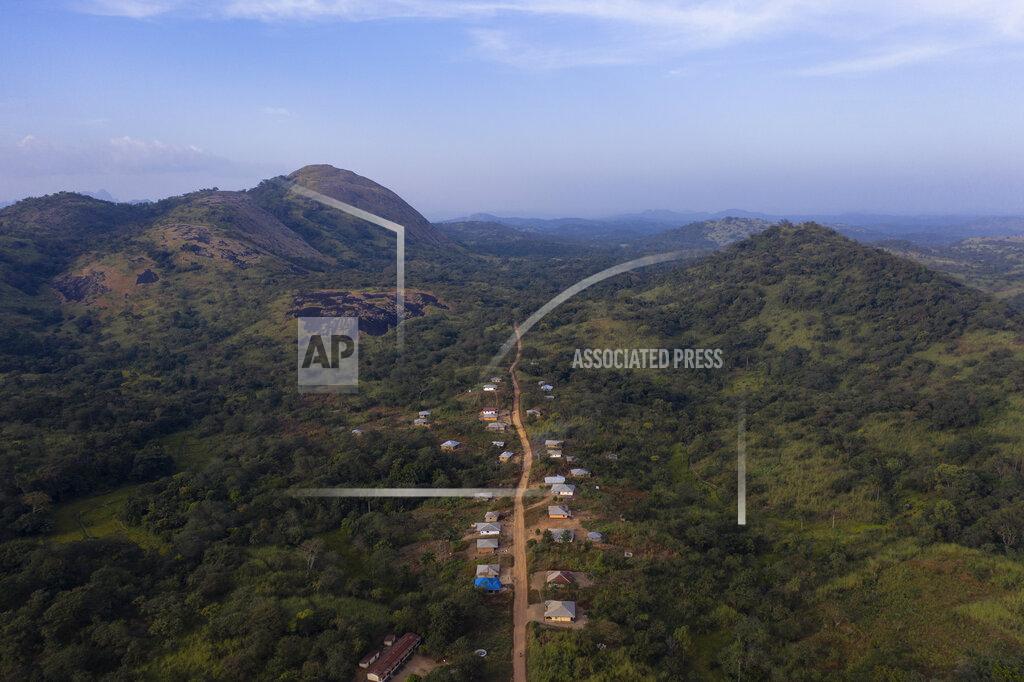Leo Correa This Thursday, Nov. 26, 2020 photo shows homes along the dirt road of Kombayendeh village, in Lei chiefdom, district of Kono, Sierra Leone. Sierra Leone closed its borders before the country had its first COVID-19 case. As a result, the country has seen only 2,434 confirmed cases and 74 deaths. Only 76 of those cases were confirmed in Kono district, but the economic toll here has brought many families already living on the edge to a breaking point. (AP Photo/Leo Correa)