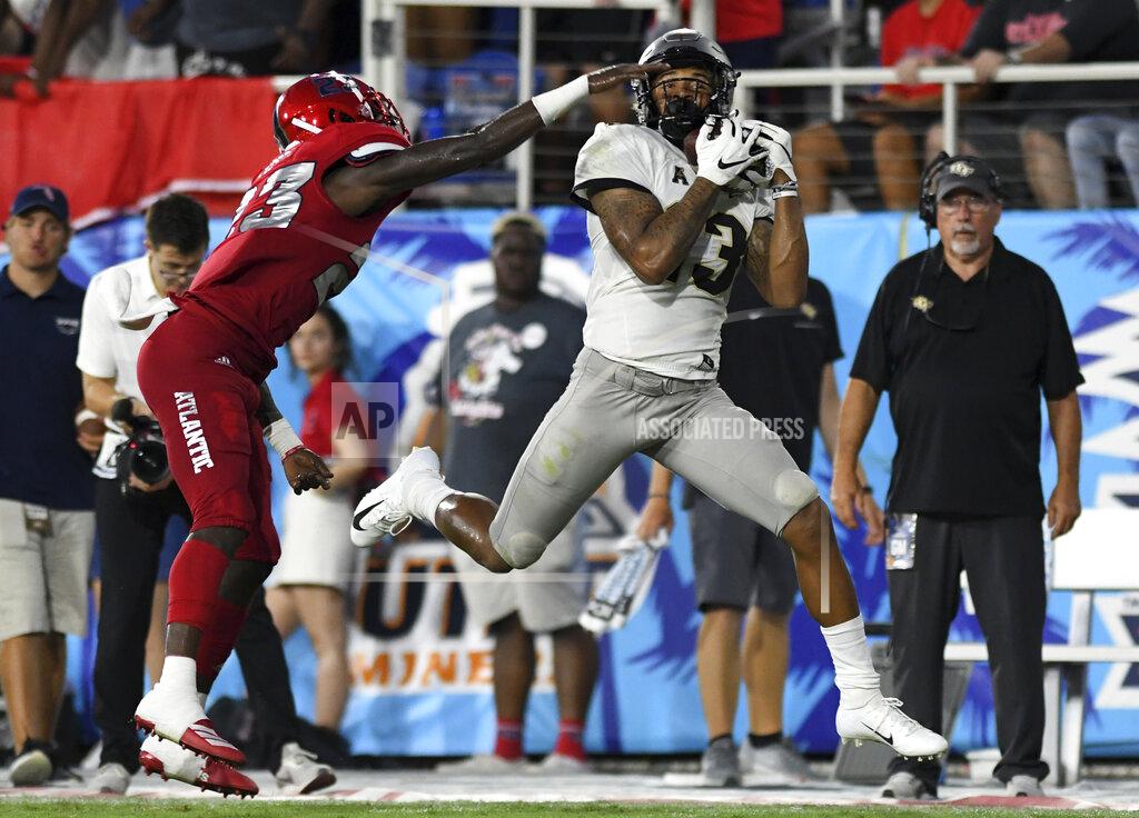 Jim Rassol UCF wide receiver Gabriel Davis hauls in a pass for a big gain as Florida Atlantic cornerback James Pierre (23) defends during the first half of an NCAA college football game Saturday, Sept. 7, 2019, in Boca Raton, Fla. (AP Photo/Jim Rassol)