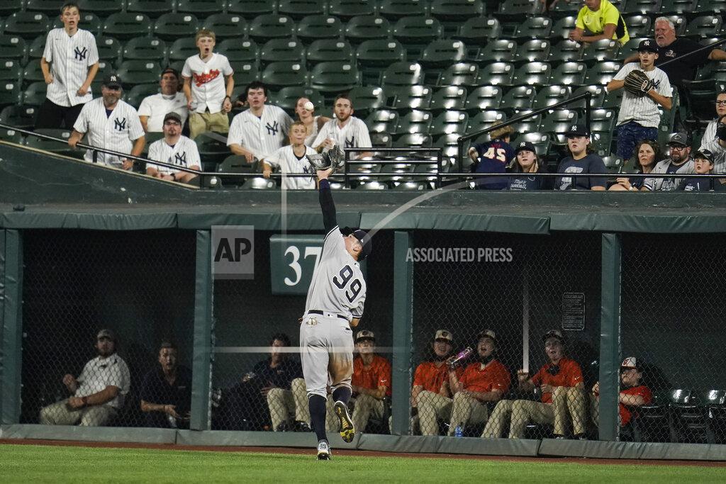 Julio Cortez New York Yankees right fielder Aaron Judge (99) reaches to make a catch on a line drive hit by Baltimore Orioles' Anthony Santander during the eighth inning of a baseball game, Tuesday, Sept. 14, 2021, in Baltimore. (AP Photo/Julio Cortez)