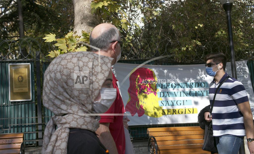 Burhan Ozbilici People wearing masks to help protect against the spread of coronavirus, walk past a billboard about the works of Leonardo da Vinci, Italian Renaissance artist, in Ankara, Turkey, Friday, Oct. 23, 2020. Turkey's Health Minister Fahrettin Koca said Friday COVID-19 infections were on the rise across the country and 40 percent of cases were in Istanbul, Turkey's most populous city with more than 15 million people.(AP Photo/Burhan Ozbilici)