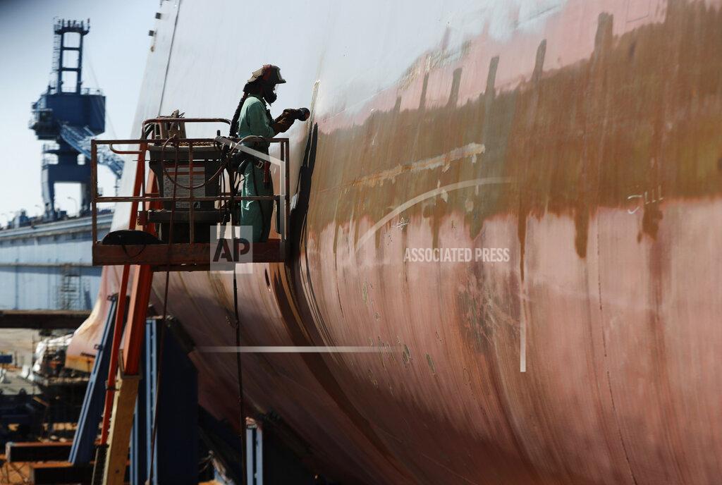 Robert F. Bukaty In this Wednesday, Aug. 29, 2018 file photo, welder Neal Larsen works on the hull a Zumwalt-class destroyer being built in the shipyard at Bath Iron Works in Bath, Maine. The return of shipbuilders after a nine-week strike, which officially ended Aug. 23, 2020, is going smoothly at Bath Iron Works and the union and company already have begun meeting to get back on track. (AP Photo/Robert F. Bukaty)