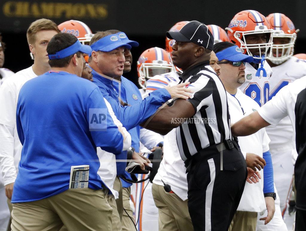 Mark Humphrey Florida head coach Dan Mullen, center, is restrained during a verbal confrontation with Vanderbilt coaches and players in the first half of an NCAA college football game Saturday, Oct. 13, 2018, in Nashville, Tenn. (AP Photo/Mark Humphrey)