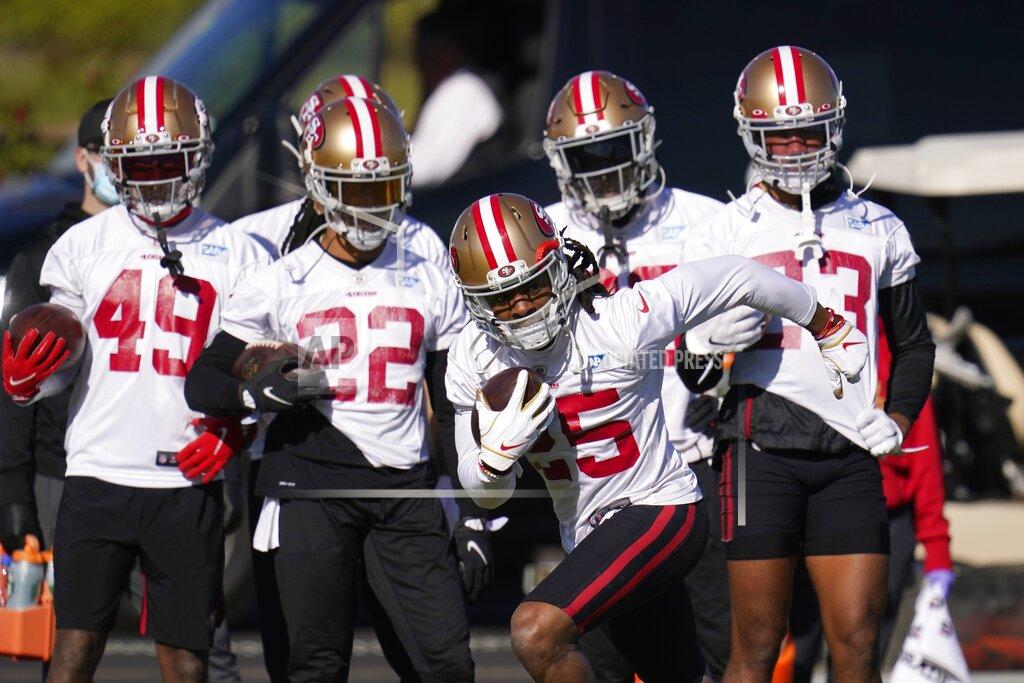 Ross D. Franklin San Francisco 49ers cornerback Richard Sherman takes off with the ball during NFL football practice near State Farm Stadium, home of the Arizona Cardinals, Thursday, Dec. 3, 2020, in Glendale, Ariz. The 49ers are on a three-week road trip after being forced from their stadium and practice facility because of strict new COVID-19 protocols in their home county in Northern California. (AP Photo/Ross D. Franklin)
