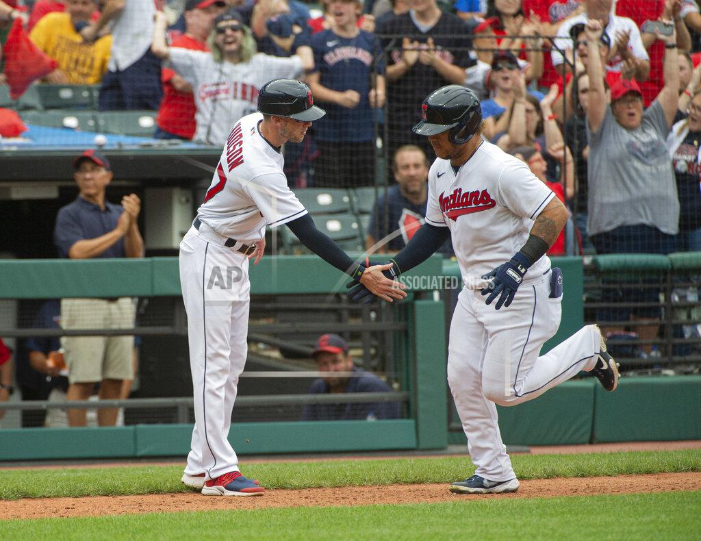 Phil Long Cleveland Indians' Harold Ramirez, right, is greeted by third base coach Kyle Hudson after hitting a solo home run off Chicago White Sox relief pitcher Craig Kimbrel during the eighth inning of a baseball game in Cleveland, Sunday, Sept. 26, 2021. (AP Photo/Phil Long)