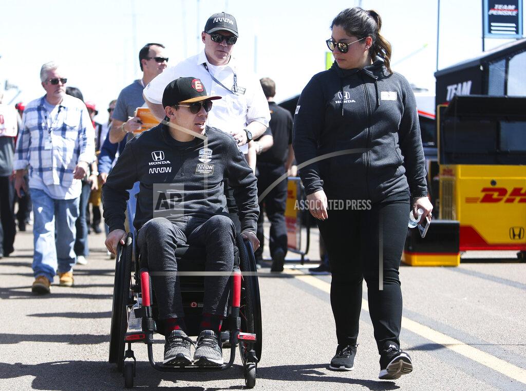 Dirk Shadd Robert Wickens, left, leaves the pit area at the IndyCar Grand Prix of St. Petersburg auto race in St. Petersburg, Fla., Friday, March 8, 2019. Wickens returned to a race track for the first time since he suffered a major spinal cord injury in a crash six months ago. (Dirk Shadd/Tampa Bay Times via AP)