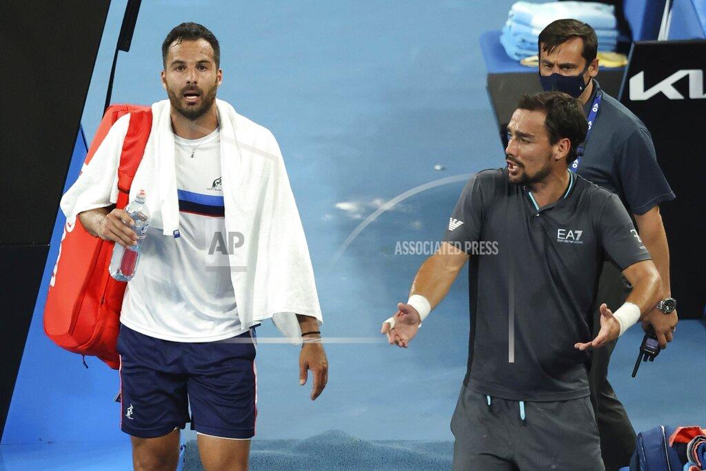 Hamish Blair Italy's Fabio Fognini, right, speaks as compatriot Salvatore Caruso walks away after their second round match at the Australian Open tennis championship in Melbourne, Australia, Thursday, Feb. 11, 2021. Fognini won the match. (AP Photo/Hamish Blair)