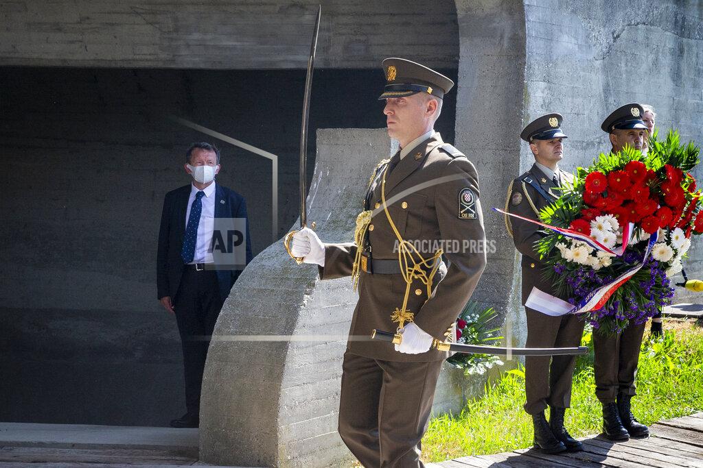 Darko Bandic Honor guards carry flowers during a commemoration ceremony for the victims of a World War II camp, in Jasenovac, Croatia, Wednesday, April 22, 2020. Representatives of the Croatian Jews, Serbs, Roma and anti-fascists for the first time in years agreed to join top Croatian officials at the ceremony, but warned this was because of the emergency situation over the new coronavirus and could change unless the authorities do more to curb right-wing sentiments in the country. (AP Photo/Darko Bandic)