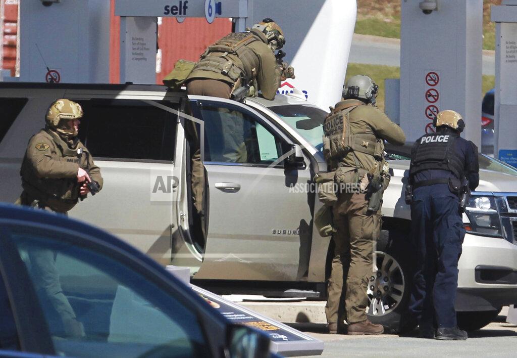 Tim Krochak Royal Canadian Mounted Police officers surround a suspect at a gas station in Enfield, Nova Scotia, Sunday April 19, 2020. Canadian police say multiple people are dead plus the suspect after a shooting rampage across the province of Nova Scotia. It was the deadliest shooting in Canada in 30 years. (Tim Krochak/The Canadian Press via AP)