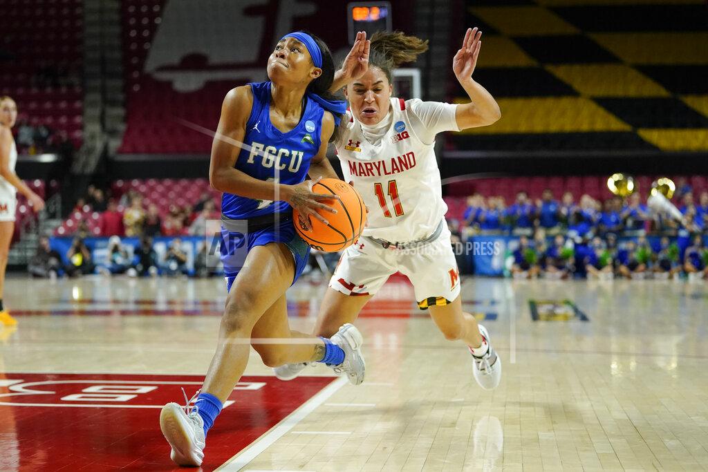 Julio Cortez Florida Gulf Coast guard Tishara Morehouse, left, drives to the basket as Maryland guard Katie Benzan loses her footing during the first half of a college basketball game in the second round of the NCAA tournament, Sunday, March 20, 2022, in College Park, Md. (AP Photo/Julio Cortez)