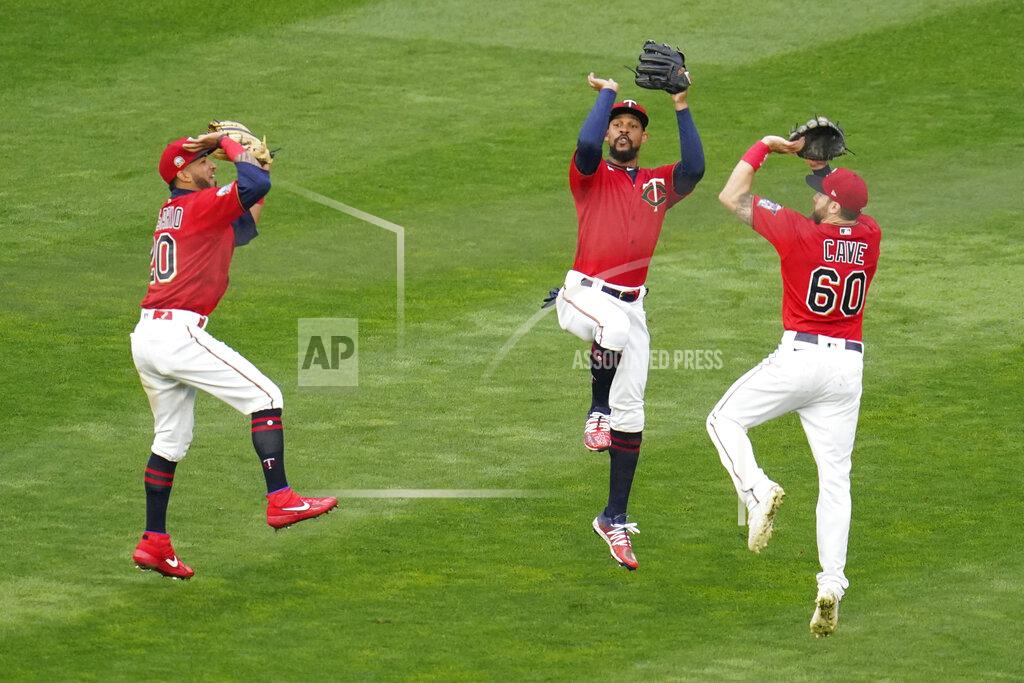 Jim Mone Minnesota Twins outfielders, from left to right, Eddie Rosario, Byron Buxton and Jake Cave show their basketball jump shot skills after they defeated the Detroit Tigers in a baseball game Monday, Sept. 7, 2020, in Minneapolis. (AP Photo/Jim Mone)