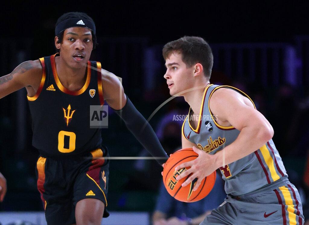 Tim Aylen In a photo provided by Bahamas Visual Services, Loyola Chicago guard Braden Norris (4) is defended by Arizona State's DJ Horne (0) during an NCAA college basketball game at Paradise Island, Bahamas, Friday, Nov. 26, 2021. (Tim Aylen/Bahamas Visual Services via AP)
