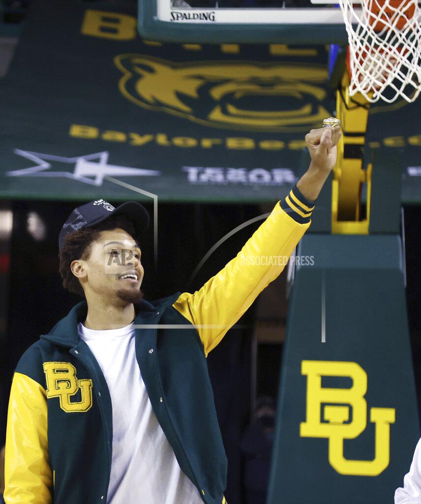 Jerry Larson Former Baylor player MaCio Teague shows off his 2021 NCAA Men's Basketball National Championship ring during a timeout in the first half of an NCAA college basketball game, Friday, Nov. 12, 2021, in Waco, Texas. (Jerry Larson/Waco Tribune-Herald via AP)