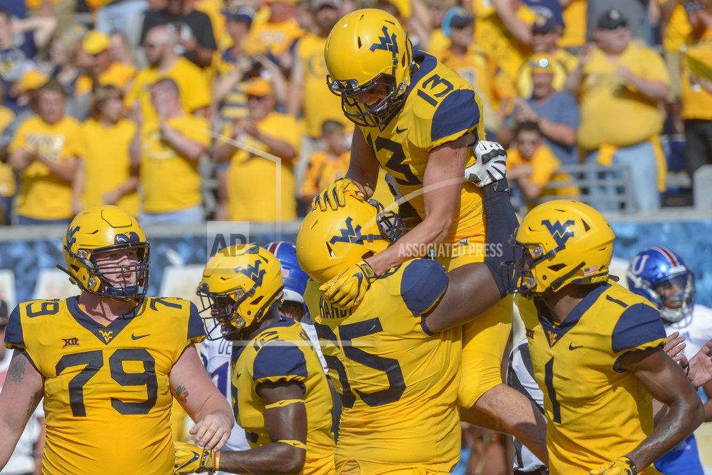 Craig Hudson West Virginia offensive lineman Isaiah Hardy (65) lifts up wide receiver David Sills V (13) after Sills scored a touchdown during the second half of an NCAA college football game against Kansas in Morgantown, W. Va., Saturday Oct. 6, 2018. (Craig Hudson/Charleston Gazette-Mail via AP)