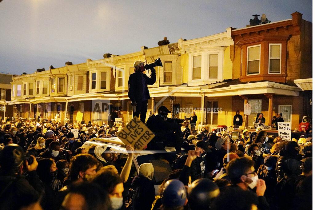 Matt Slocum FILE — In this Oct. 27, 2020 file photo, protesters confront police during a march in Philadelphia over the death of Walter Wallace, a Black man who was killed by police in Philadelphia. (AP Photo/Matt Slocum, File)