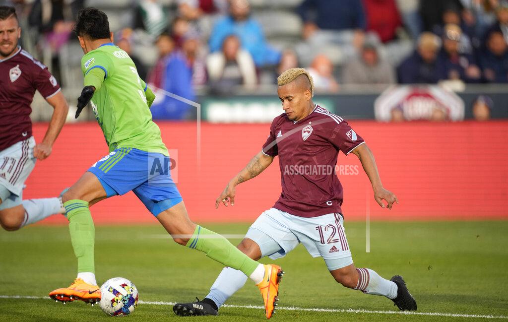David Zalubowski Colorado Rapids forward Michael Barrios, right, passes the ball between the legs of Seattle Sounders defender Xavier Arreaga in the second half of an MLS soccer match, Sunday, May 22 2022, in Commerce City, Colo. (AP Photo/David Zalubowski)