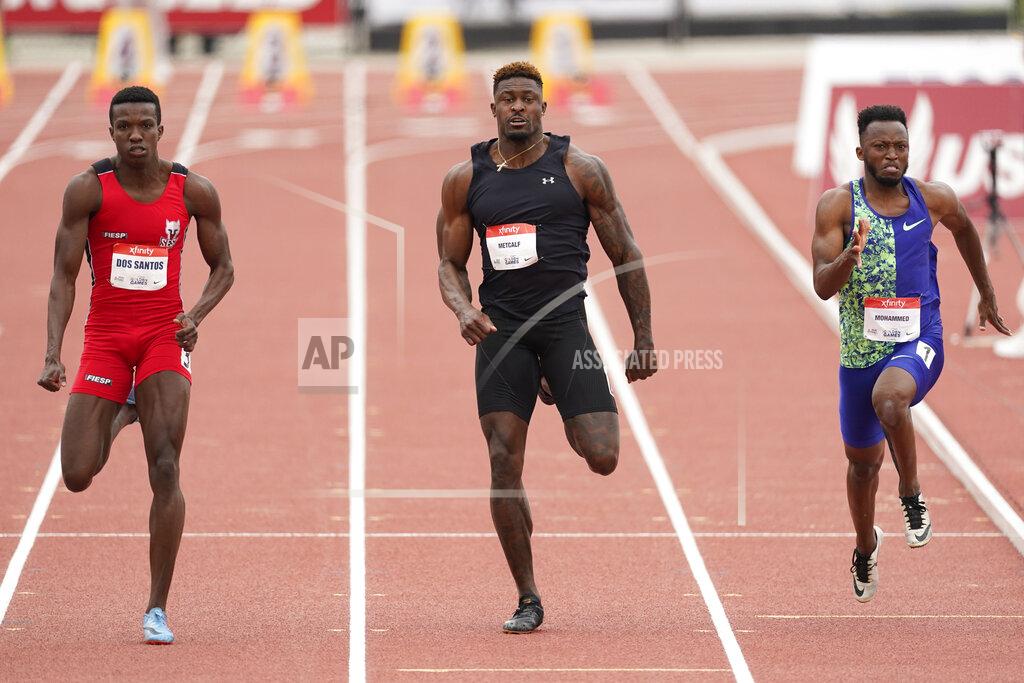Ashley Landis Seattle Seahawks wide receiver DK Metcalf, center, competes in the second heat of the men's 100-meter dash prelim during the USATF Golden Games at Mt. San Antonio College Sunday, May 9, 2021, in Walnut, Calif. At left is Felipe Bardi Dos Santos and at right is Abdullah Mohammed. (AP Photo/Ashley Landis)