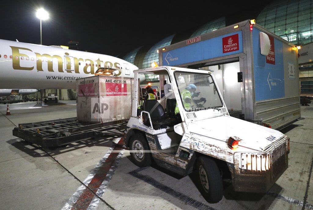 Kamran Jebreili A Pfizer-BioNTech COVID-19 coronavirus vaccines shipment is offloaded from an Emirates Airlines Boing 777 that arrived from Brussels at Dubai International Airport in Dubai, United Arab Emirates, early Sunday, Feb. 21, 2021. As the coronavirus pandemic continues to clobber the aviation industry, Emirates Airlines, the Middle East’s biggest airline is seeking to play a vital role in the global vaccine delivery effort. (AP Photo/Kamran Jebreili)