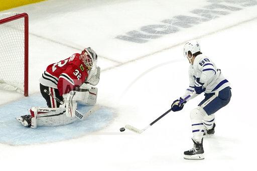 Toronto Maple Leafs' William Nylander (88) shoots and scores the game winning goal during an overtime period of an NHL hockey game Wednesday, Oct. 27, 2021, in Chicago. The Maple Leafs won 3-2. (AP Photo/Charles Rex Arbogast)