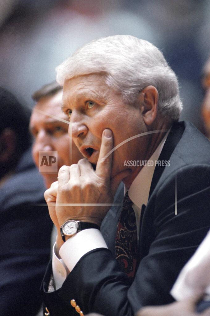 FILE - In this March 19, 1993, file photo, Arizona coach Lute Olson watches his team during a loss to Santa Clara in an NCAA men's college basketball tournament game in Salt Lake City. Olson, the Hall of Fame coach who turned Arizona into a college basketball powerhouse, has died. He was 85. Olson’s family said he died Thursday evening, Aug. 27, 2020. The family didn't provide the cause of death. (AP Photo/Jack Smith, File)