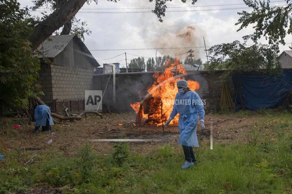 Dar Yasin An Indian paramilitary soldier walks back after performing religious rituals during the cremation of his colleague who died of COVID-19, at a crematorium in Srinagar, Indian controlled Kashmir, Saturday, July 18, 2020. India crossed 1 million coronavirus cases on Friday, third only to the United States and Brazil, prompting concerns about its readiness to confront an inevitable surge that could overwhelm hospitals and test the country's feeble health care system. (AP Photo/Dar Yasin)