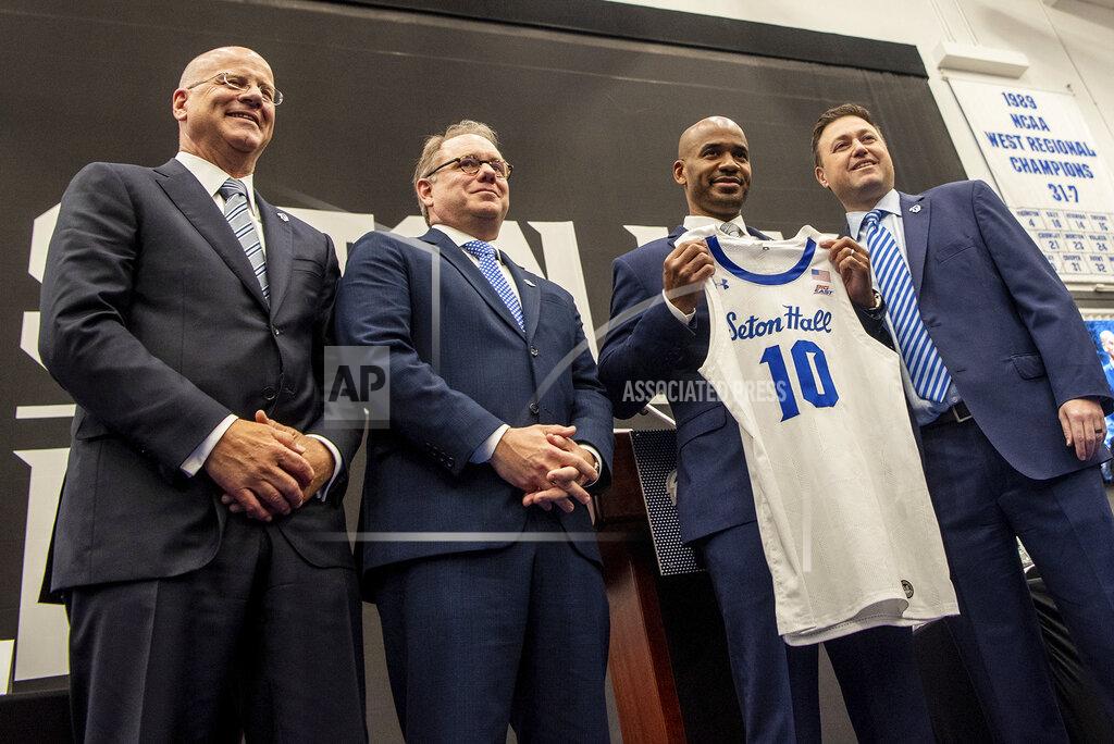 Anne-Marie Caruso Kevin Marino, chair of the Seton Hall University Board of Regents, from left, Seton Hall President Joseph E. Nyre, and SHU Athletic Director Bryan Felt, welcome Shaheen Holloway, second right, as the new men's basketball head coach during a press conference at Seton Hall in South Orange, N.J., Thursday March 31, 2022. (Anne-Marie Caruso/The Record via AP)