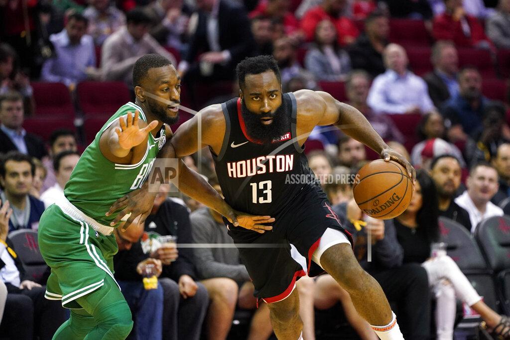 Houston Rockets' James Harden (13) drives toward the basket as Boston Celtics' Kemba Walker defends during the first half of an NBA basketball game Tuesday, Feb. 11, 2020, in Houston. (AP Photo/David J. Phillip)