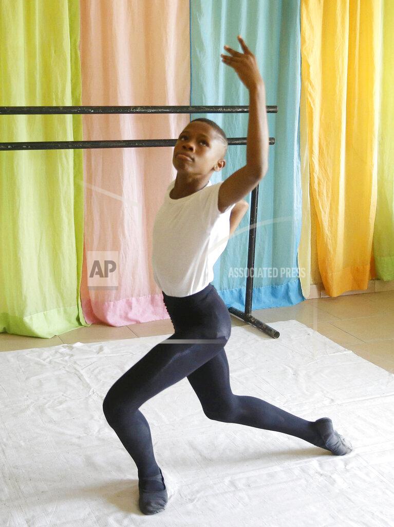 Sunday Alamba FILE - Ballet dancer Anthony Mmesoma Madu rehearses in Lagos, Nigeria on Aug. 18, 2020. The 11-year-old gained fame through a simple cellphone video of him performing the pirouette without shoes in the drizzling rain in Nigeria earlier this year. By the end of August, the video garnered more than 20 million views on social media including by actor Cynthia Erivo, who decided to sponsor Madu's training and helped bring the video to the attention of the New York-based American Ballet Theater, who offered him a scholarship. (AP Photo/Sunday Alamba, File)