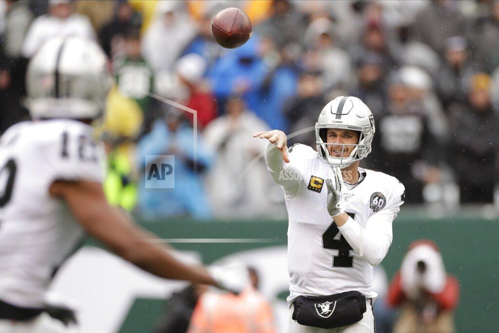 Seth Wenig Oakland Raiders quarterback Derek Carr (4) throws a pass to Zay Jones (12) during the first half of an NFL football game Sunday, Nov. 24, 2019, in East Rutherford, N.J. (AP Photo/Adam Hunger)
